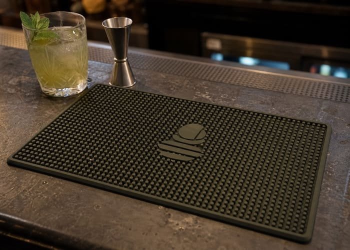 Custom Bar Mat Market Trends 2026 A stylish custom bar mat on a modern bar counter, showcasing a matte finish and minimalist logo, representing 2026 market trends.