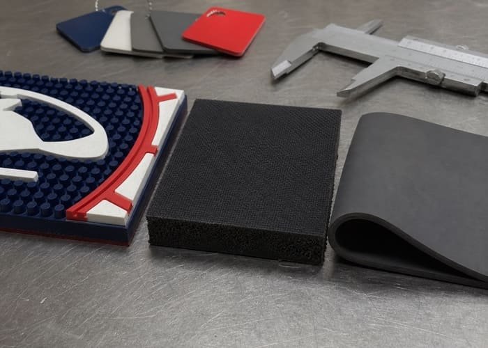 Bar Mat Material Optionsрезин A close-up comparison of PVC, rubber, and silicone material samples at a bar mat factory.