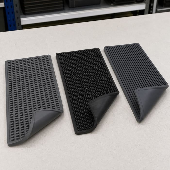 A close-up comparison of PVC, rubber, and silicone bar mat materials