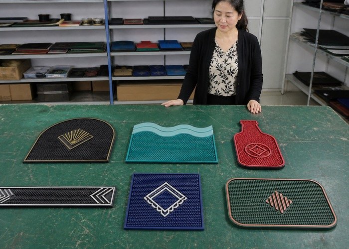 A collection of creative custom bar mat design ideas with unique shapes and colors