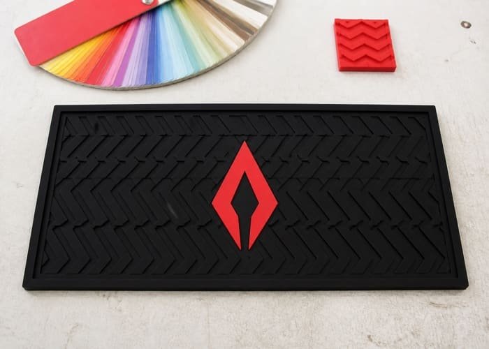 Close-up of a logo on a custom bar mat showing the ideal one-third size proportion