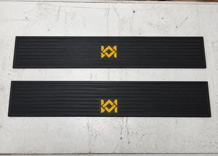 A well-designed custom bar mat with a 3D embossed logo in the center
