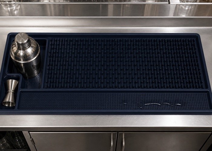 A detailed diagram of a functional bar mat showing different zones for draining, wiping, and tool placement.