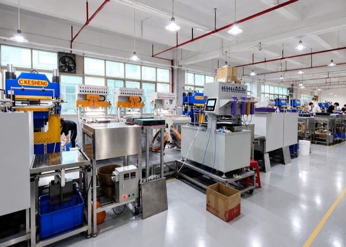 A large, modern factory floor with many workers and machines