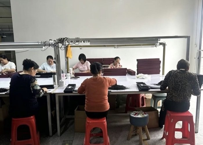 A production manager at SuperfectCraft overseeing the mat production line and checking progress against a schedule.